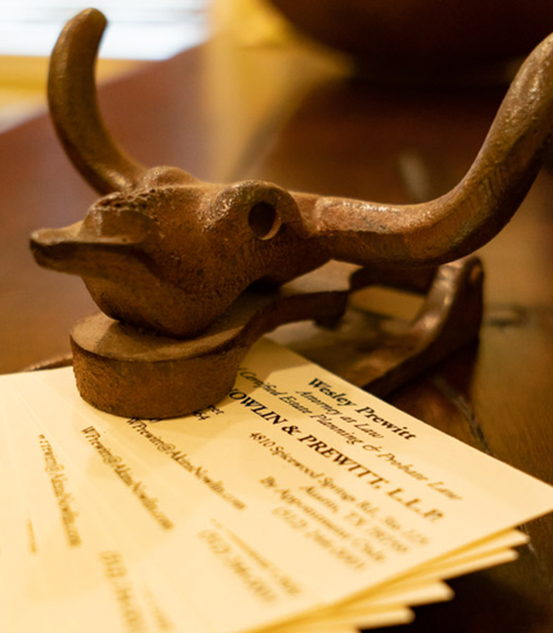 rusted longhorn paperweight stacked on legal paperwork